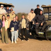 Volunteers united in Kruger National Park, embracing nature's beauty and conservation.