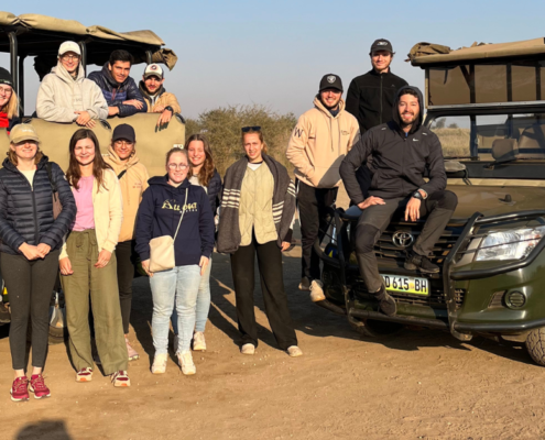 Volunteers united in Kruger National Park, embracing nature's beauty and conservation.