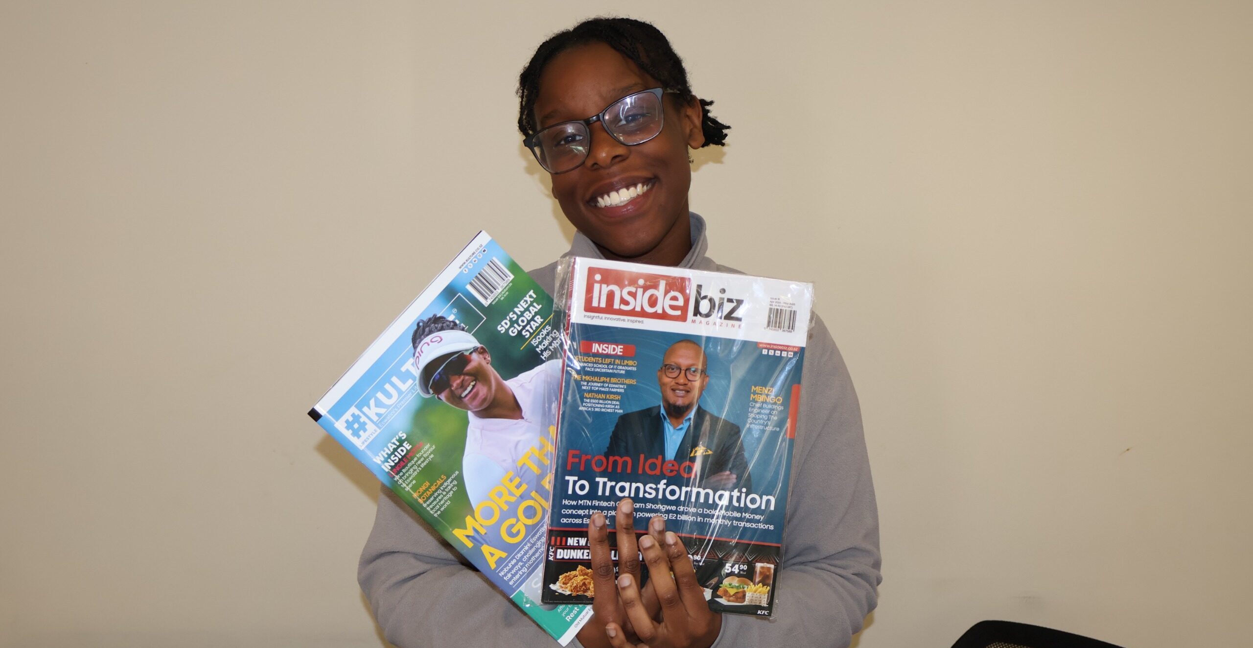 Hilda Najjumba holding Inside Biz and Kulture magazines during her journalism internship in Eswatini